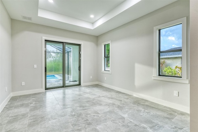 22 Medalist Cir, Rotonda West, FL 33947 - empty room with baseboards, visible vents, recessed lighting, and a tray ceiling