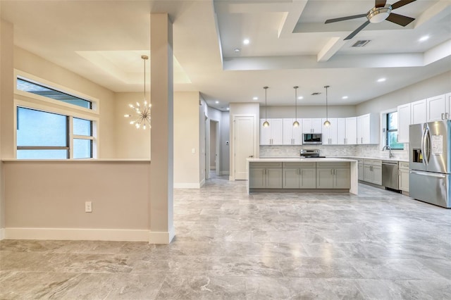 22 Medalist Cir, Rotonda West, FL 33947 - kitchen featuring visible vents, stainless steel appliances, light countertops, and a raised ceiling