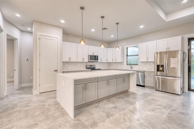 22 Medalist Cir, Rotonda West, FL 33947 - kitchen with tasteful backsplash, stainless steel appliances, a center island, and a sink