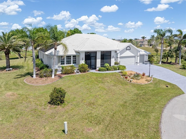 single story home with an attached garage, driveway, a front yard, and stucco siding