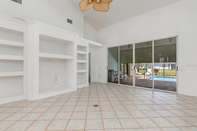 unfurnished living room featuring high vaulted ceiling, built in shelves, ceiling fan, tile patterned flooring, and visible vents