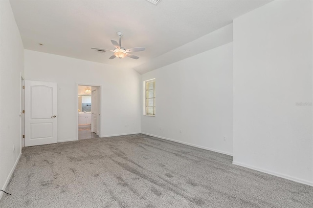 carpeted spare room with ceiling fan and baseboards