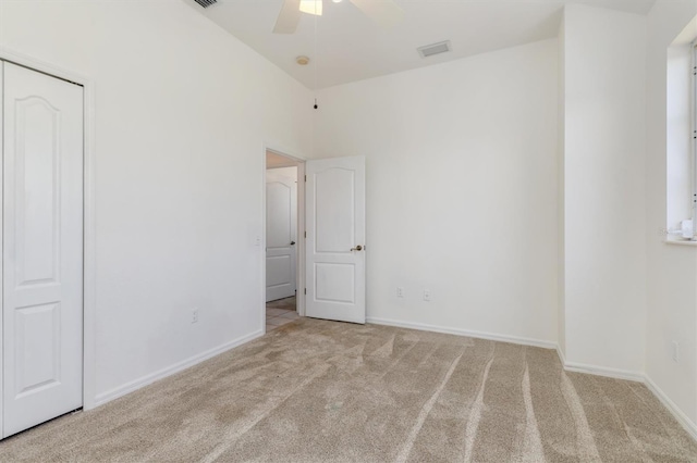 unfurnished bedroom with visible vents, carpet flooring, baseboards, and ceiling fan