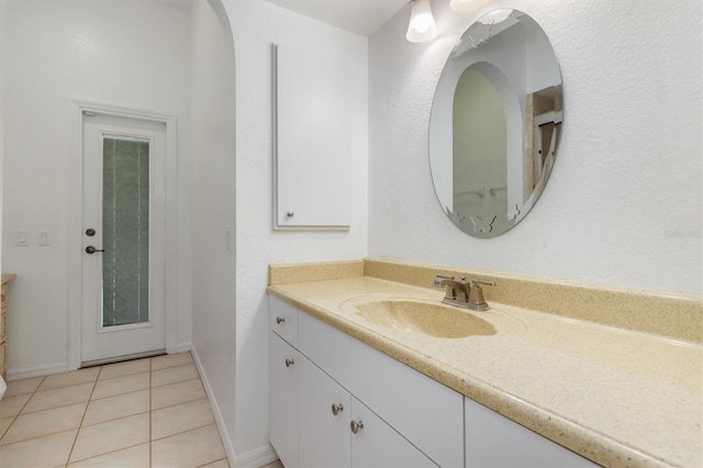 bathroom featuring baseboards, vanity, and tile patterned floors