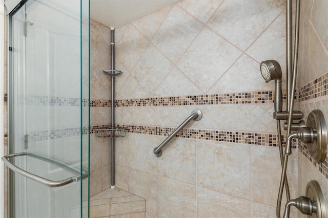 full bath featuring a shower stall