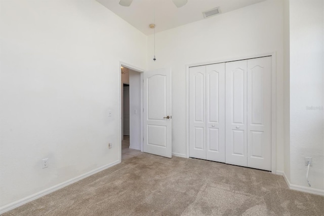 unfurnished bedroom with a ceiling fan, a closet, baseboards, carpet flooring, and visible vents