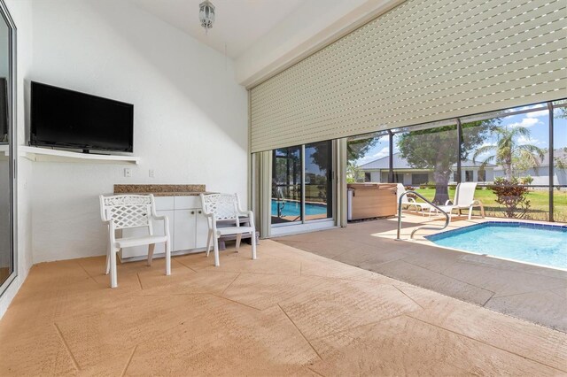 outdoor pool with a patio area
