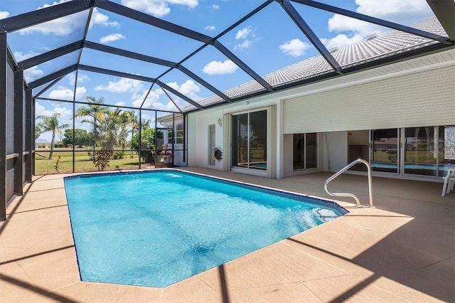 pool featuring glass enclosure and a patio area