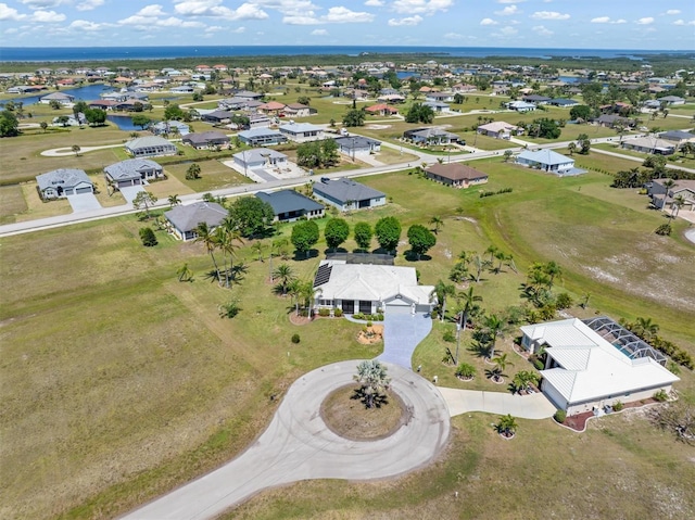 bird's eye view featuring a residential view and a water view