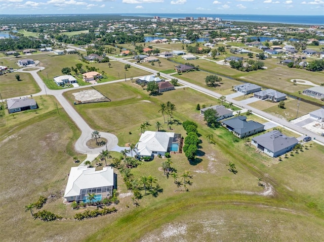 drone / aerial view featuring a residential view and a water view