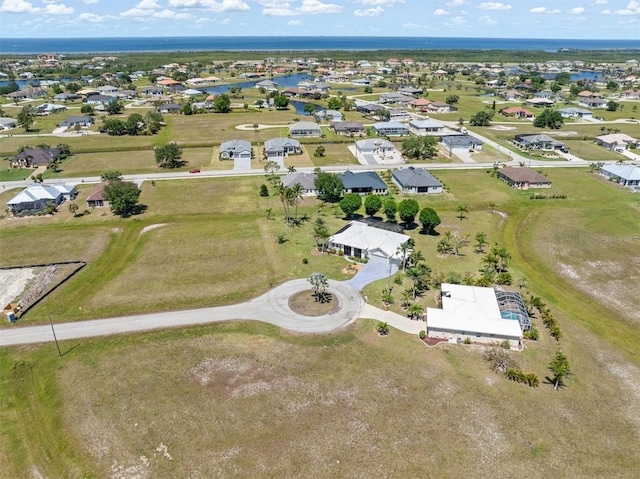 drone / aerial view with a residential view and a water view