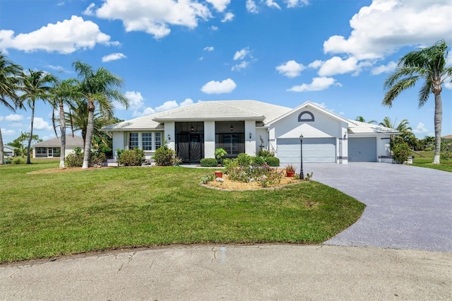single story home with an attached garage, a front lawn, stucco siding, and driveway
