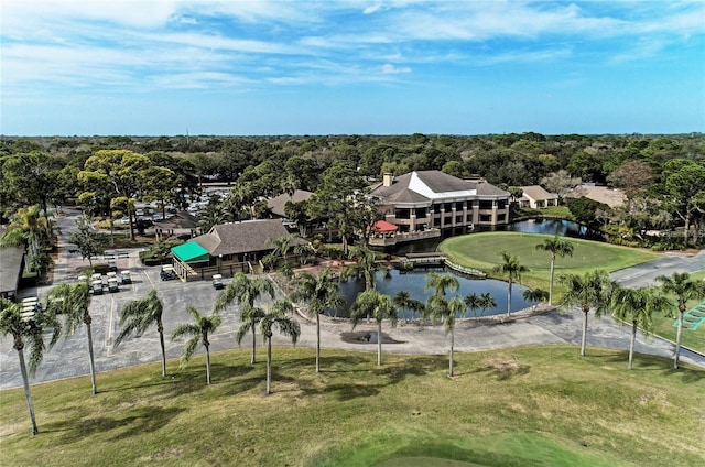 exterior space with view of golf course and a water view
