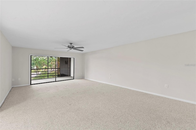 spare room featuring baseboards, a ceiling fan, and carpet flooring