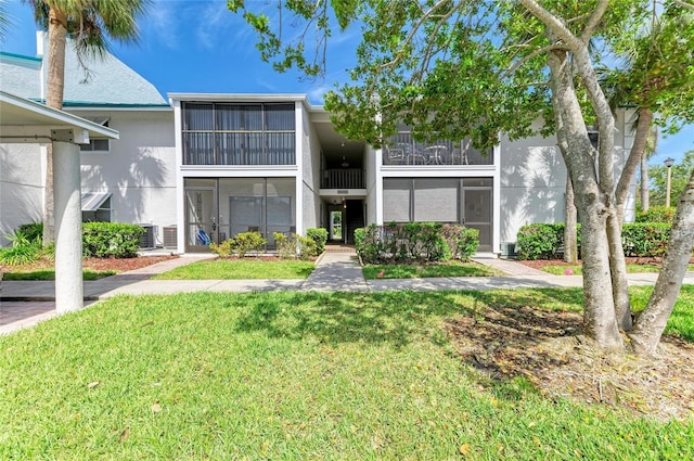 exterior space with a front yard and stucco siding