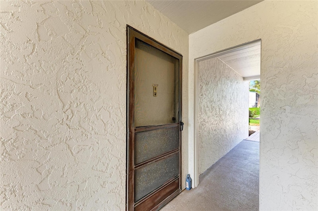 entrance to property featuring stucco siding