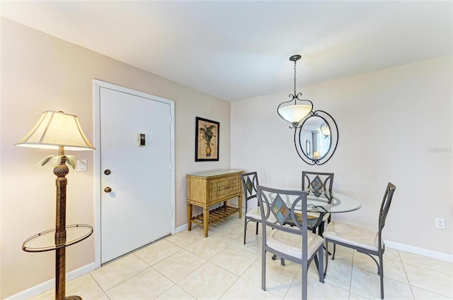 dining area featuring baseboards and light tile patterned floors