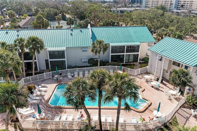 pool with a fenced backyard and a patio area