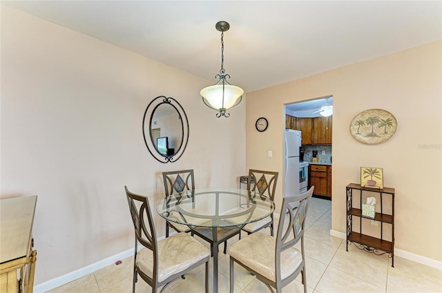 dining area with baseboards and light tile patterned floors