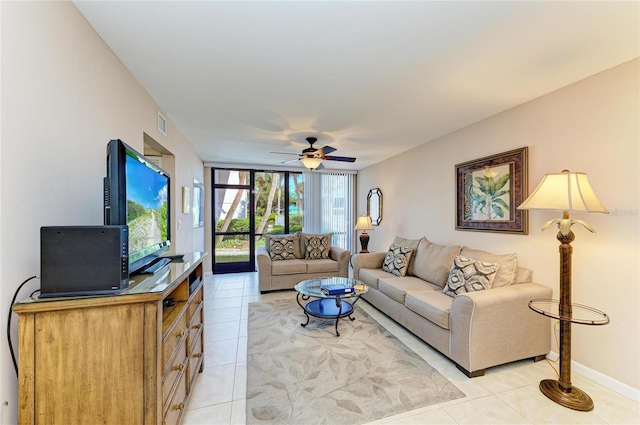 living room with ceiling fan, baseboards, visible vents, and light tile patterned floors