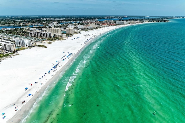 aerial view with a beach view, a water view, and a view of city