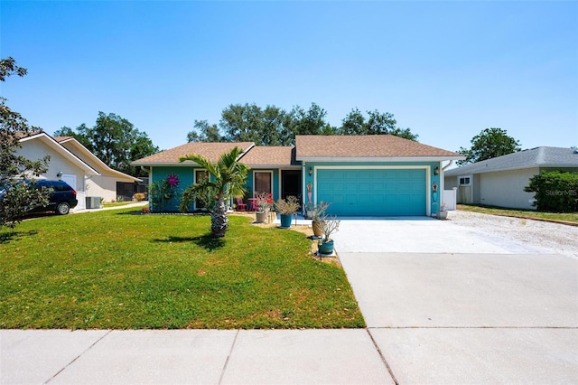 4219 Berkshire Dr, Sarasota, FL 34241 - ranch-style house featuring an attached garage, driveway, a front lawn, and stucco siding