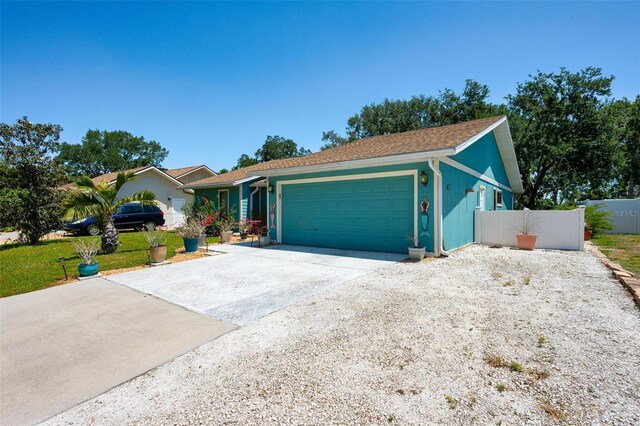 4219 Berkshire Dr, Sarasota, FL 34241 - ranch-style house featuring fence, concrete driveway, a front lawn, and a garage