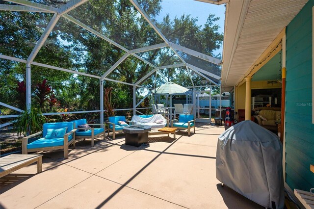 4219 Berkshire Dr, Sarasota, FL 34241 - view of patio featuring a lanai, an outdoor living space with a fire pit, and area for grilling