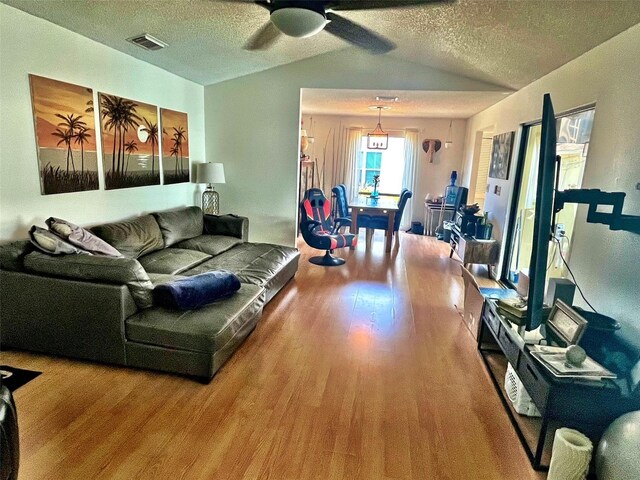 4219 Berkshire Dr, Sarasota, FL 34241 - living area with wood finished floors, visible vents, a ceiling fan, a textured ceiling, and lofted ceiling