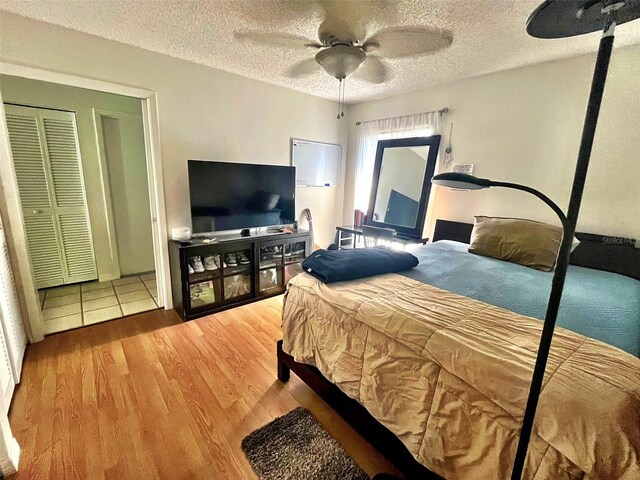 4219 Berkshire Dr, Sarasota, FL 34241 - bedroom featuring a textured ceiling, wood finished floors, and ceiling fan