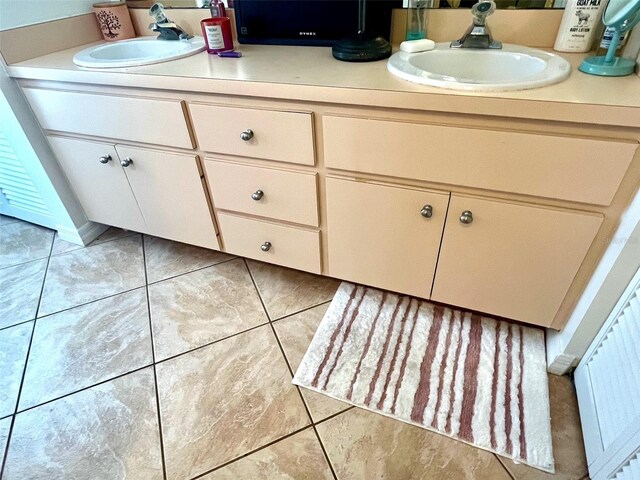 4219 Berkshire Dr, Sarasota, FL 34241 - bathroom with tile patterned floors, double vanity, and a sink