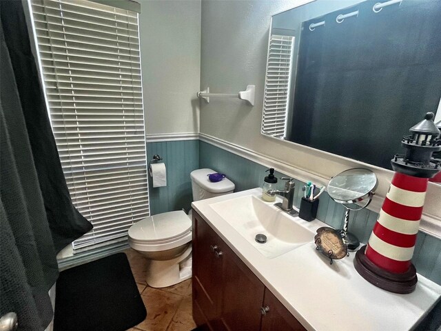 4219 Berkshire Dr, Sarasota, FL 34241 - half bath with wainscoting, toilet, and vanity