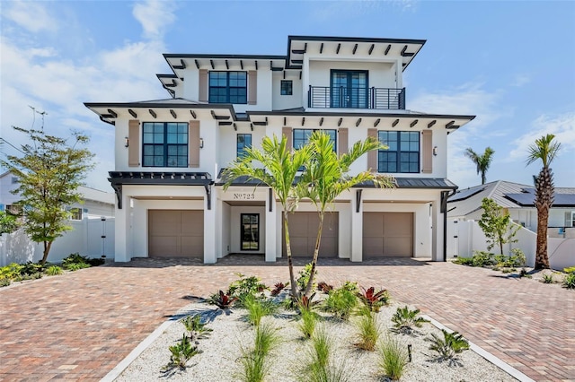 723 S Blvd Of The Presidents, Sarasota, FL 34236 - view of front of home with stucco siding, an attached garage, a balcony, and decorative driveway
