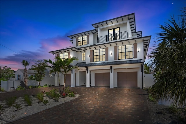 723 S Blvd Of The Presidents, Sarasota, FL 34236 - coastal home featuring a balcony, stucco siding, an attached garage, a standing seam roof, and decorative driveway