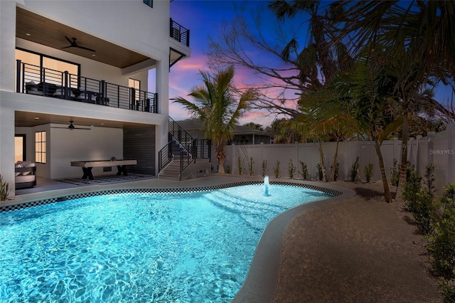 723 S Blvd Of The Presidents, Sarasota, FL 34236 - pool at dusk with fence, a ceiling fan, and stairs