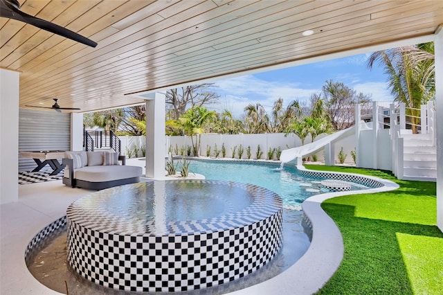 723 S Blvd Of The Presidents, Sarasota, FL 34236 - view of swimming pool featuring a water slide, a fenced in pool, a fenced backyard, ceiling fan, and a patio