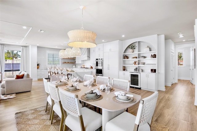 723 S Blvd Of The Presidents, Sarasota, FL 34236 - dining space featuring beverage cooler, light wood-style floors, baseboards, visible vents, and recessed lighting