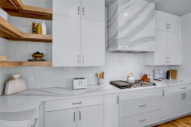 723 S Blvd Of The Presidents, Sarasota, FL 34236 - kitchen featuring premium range hood, white cabinets, open shelves, and stainless steel gas stovetop