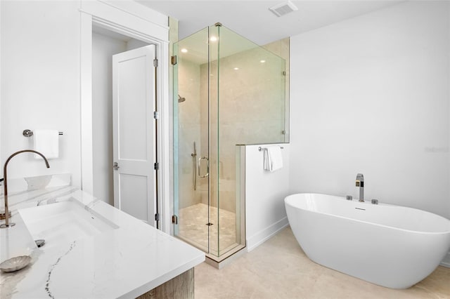 723 S Blvd Of The Presidents, Sarasota, FL 34236 - bathroom featuring visible vents, vanity, baseboards, a soaking tub, and a stall shower