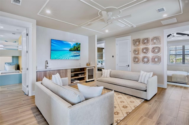 723 S Blvd Of The Presidents, Sarasota, FL 34236 - living area with light wood finished floors, visible vents, beverage cooler, and ceiling fan
