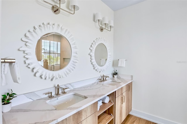 723 S Blvd Of The Presidents, Sarasota, FL 34236 - bathroom with double vanity, wood finished floors, baseboards, and a sink