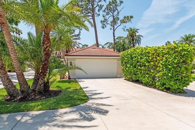 7639 Fairway Woods Dr Unit 605, Sarasota, FL 34238 - view of front of house featuring driveway, a tiled roof, and stucco siding