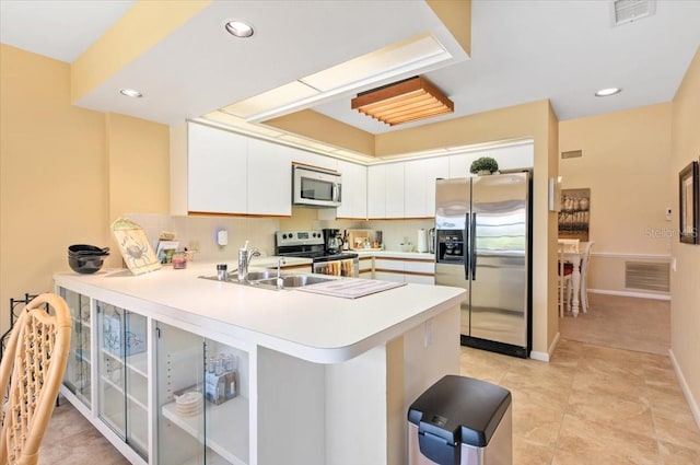 7639 Fairway Woods Dr Unit 605, Sarasota, FL 34238 - kitchen with a peninsula, light countertops, visible vents, and stainless steel appliances