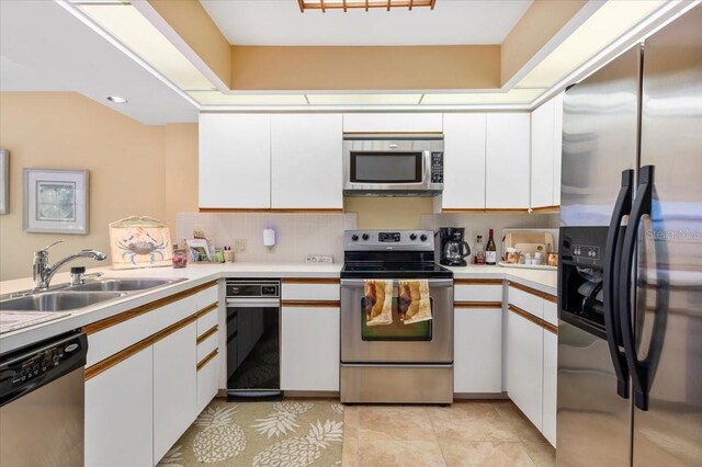 7639 Fairway Woods Dr Unit 605, Sarasota, FL 34238 - kitchen with a sink, light tile patterned floors, light countertops, white cabinets, and appliances with stainless steel finishes