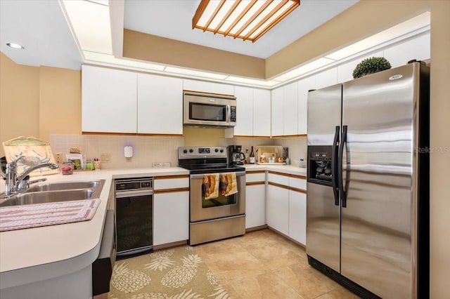 7639 Fairway Woods Dr Unit 605, Sarasota, FL 34238 - kitchen with light countertops, appliances with stainless steel finishes, white cabinetry, and a sink