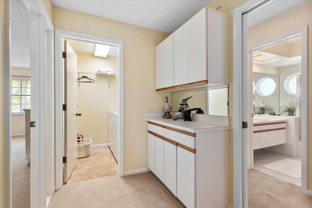 7639 Fairway Woods Dr Unit 605, Sarasota, FL 34238 - corridor with washing machine and dryer and light colored carpet