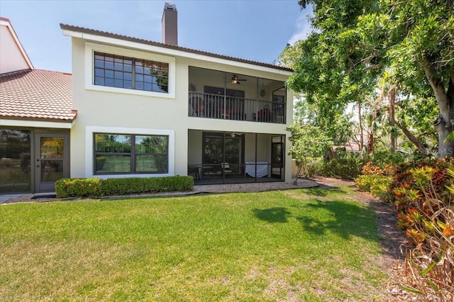 7639 Fairway Woods Dr Unit 605, Sarasota, FL 34238 - rear view of house featuring a chimney, a tiled roof, a balcony, a yard, and stucco siding
