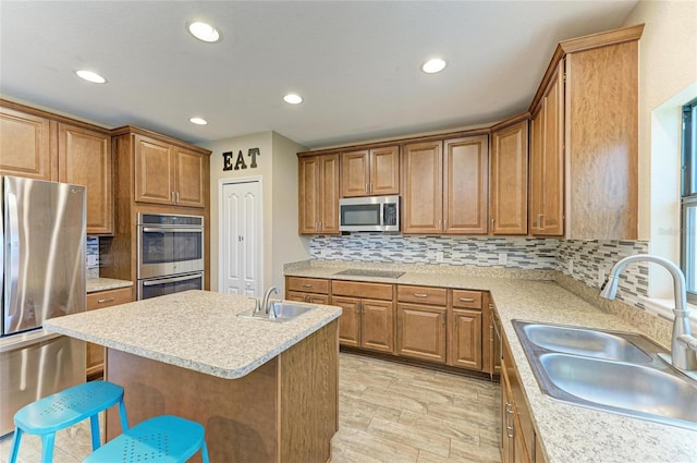 2084 La Palma Ave, Port Charlotte, FL 33953 - kitchen featuring stainless steel appliances, a sink, a breakfast bar area, brown cabinets, and recessed lighting