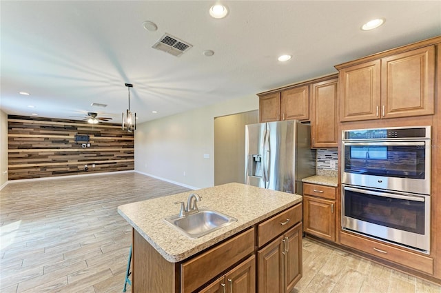 2084 La Palma Ave, Port Charlotte, FL 33953 - kitchen featuring appliances with stainless steel finishes, a sink, baseboards, light wood-style floors, and recessed lighting