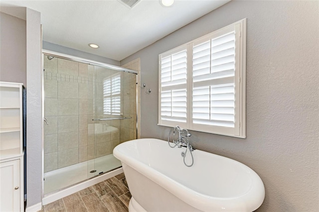 2084 La Palma Ave, Port Charlotte, FL 33953 - bathroom with a freestanding tub, a shower stall, wood finish floors, and recessed lighting
